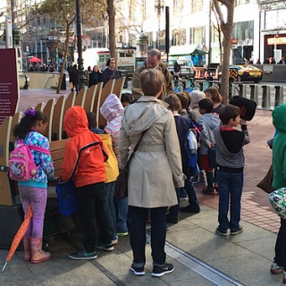 Kids singing at a bench. Pause on Market by Exploratorium's Studio for Public Spaces. Photo courtesy of artist. • <a style="font-size:0.8em;" href="http://www.flickr.com/photos/54560762@N04/21475521250/" target="_blank">View on Flickr</a>